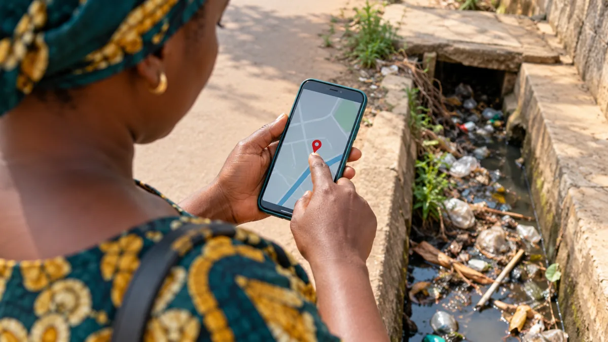 Illustration of a resident placing a public issue location pin on a smartphone map
